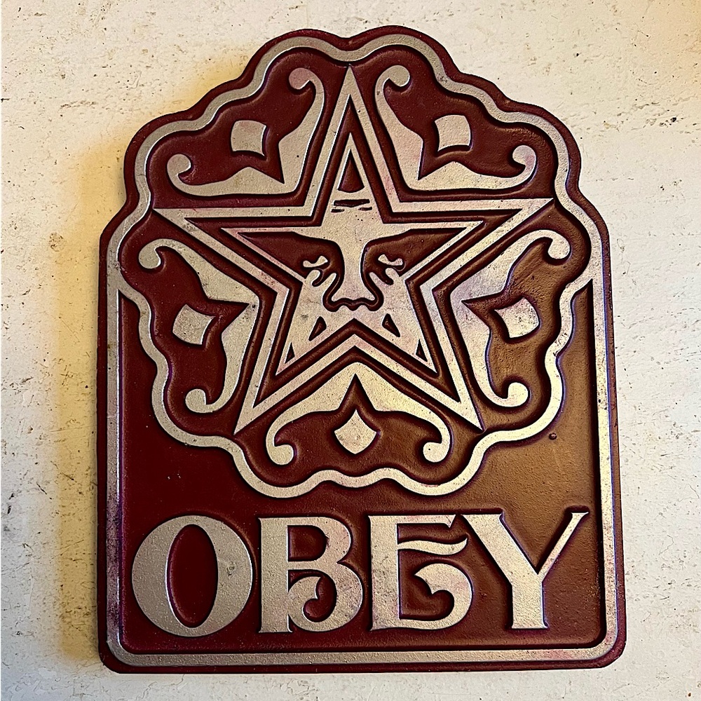 OBEY decorative metal plaque